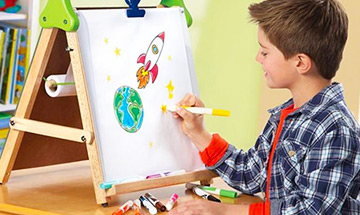 toddler painting on easel